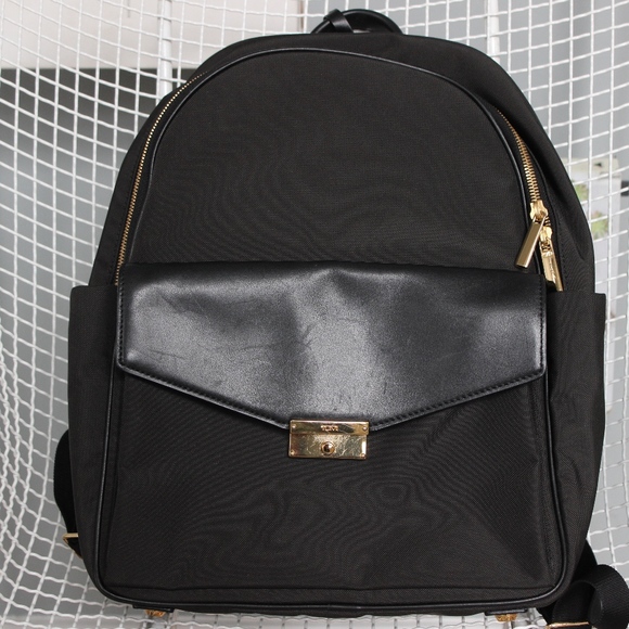 tumi black and gold backpack